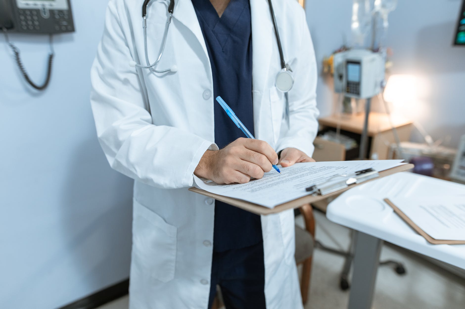 doctor writing on a medical chart